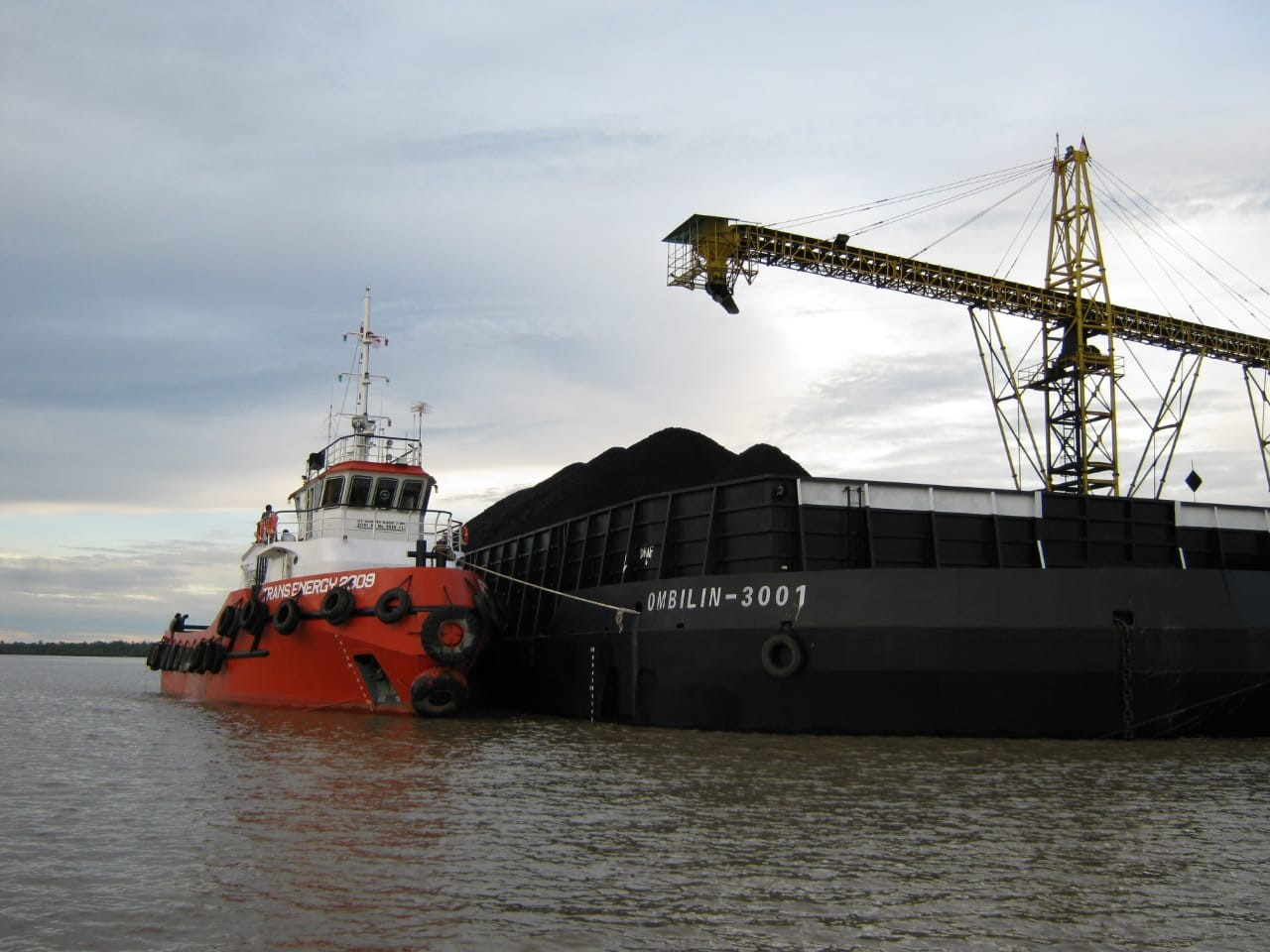 Ombilin coal barge and tugboat at port